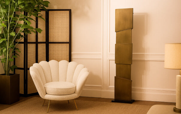 Light That Speaks as Sculpture- Decorative room with a shell-shaped chair, plant, and tall lamp.