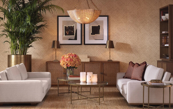 Spaces That Work Harder- Living room with white sofa, coffee table, and decorative elements.
