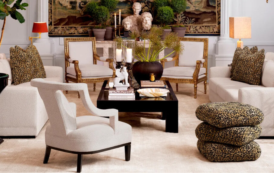 Luxury living room with white furniture, decorative pillows, and a coffee table.