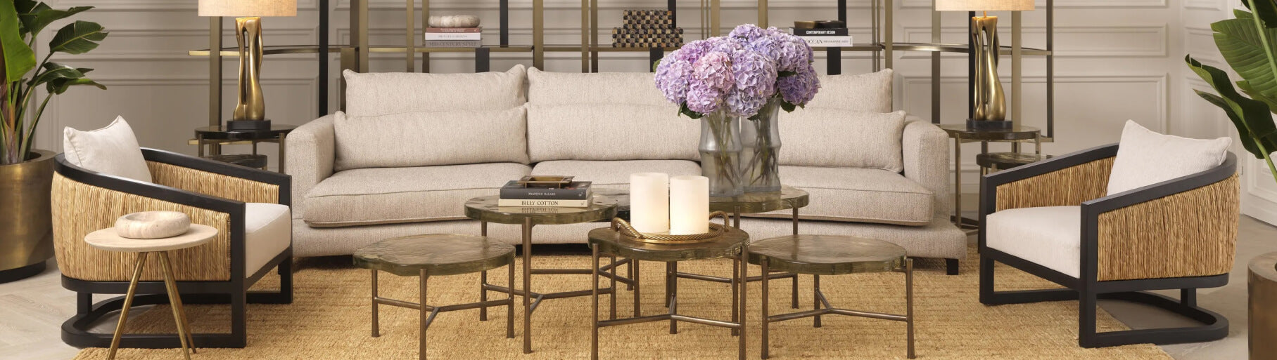 Modern living room with beige sofa, armchairs, and decorative elements.