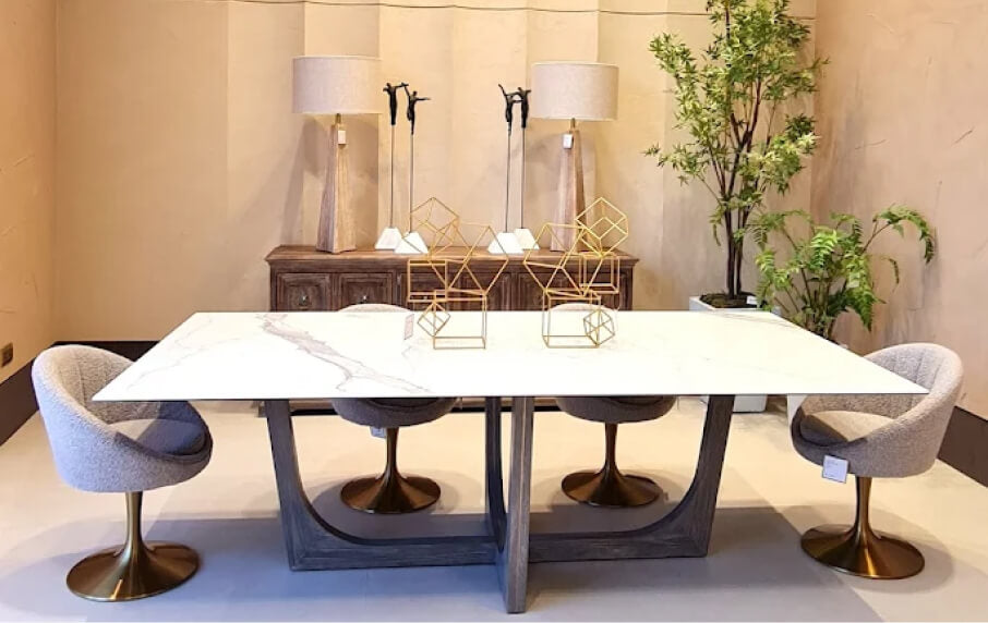 Modern dining set with a white table and gray chairs in a room with decorative elements.